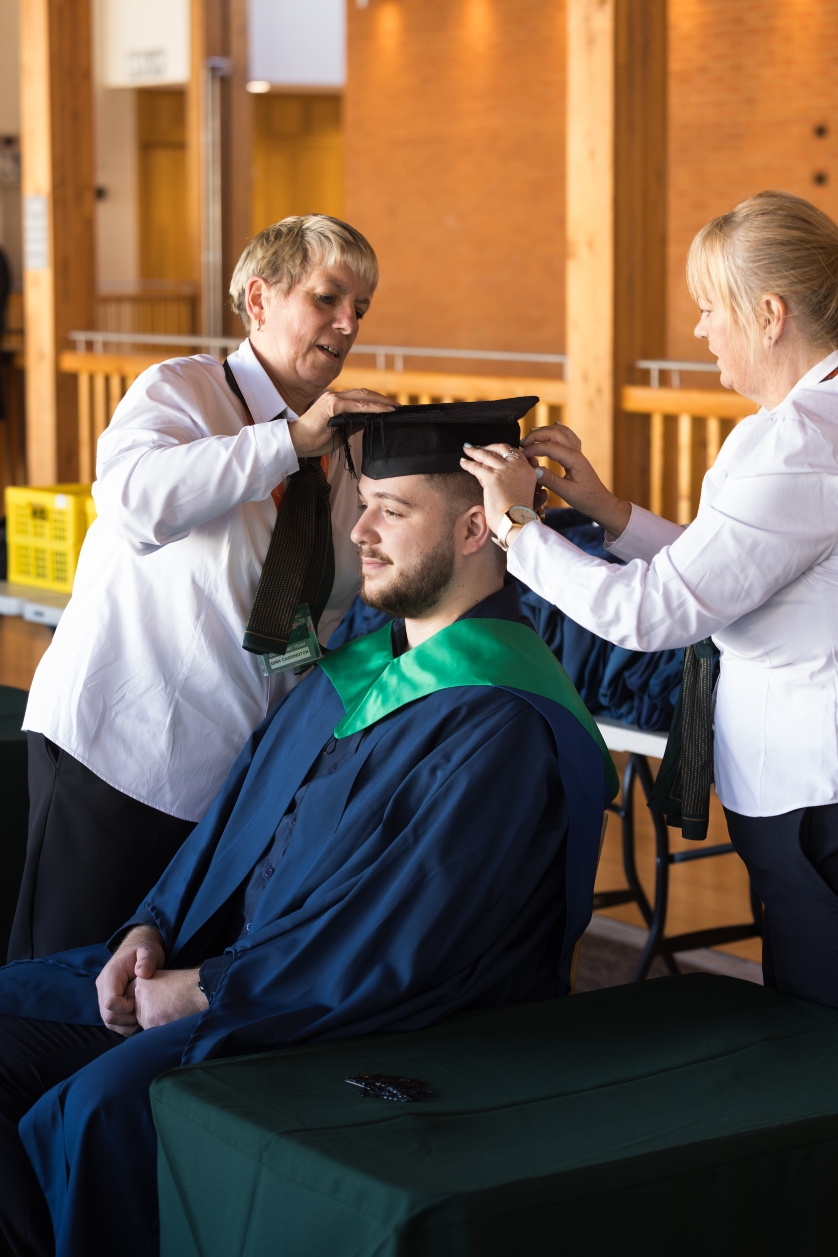 A graduate getting gowned up.