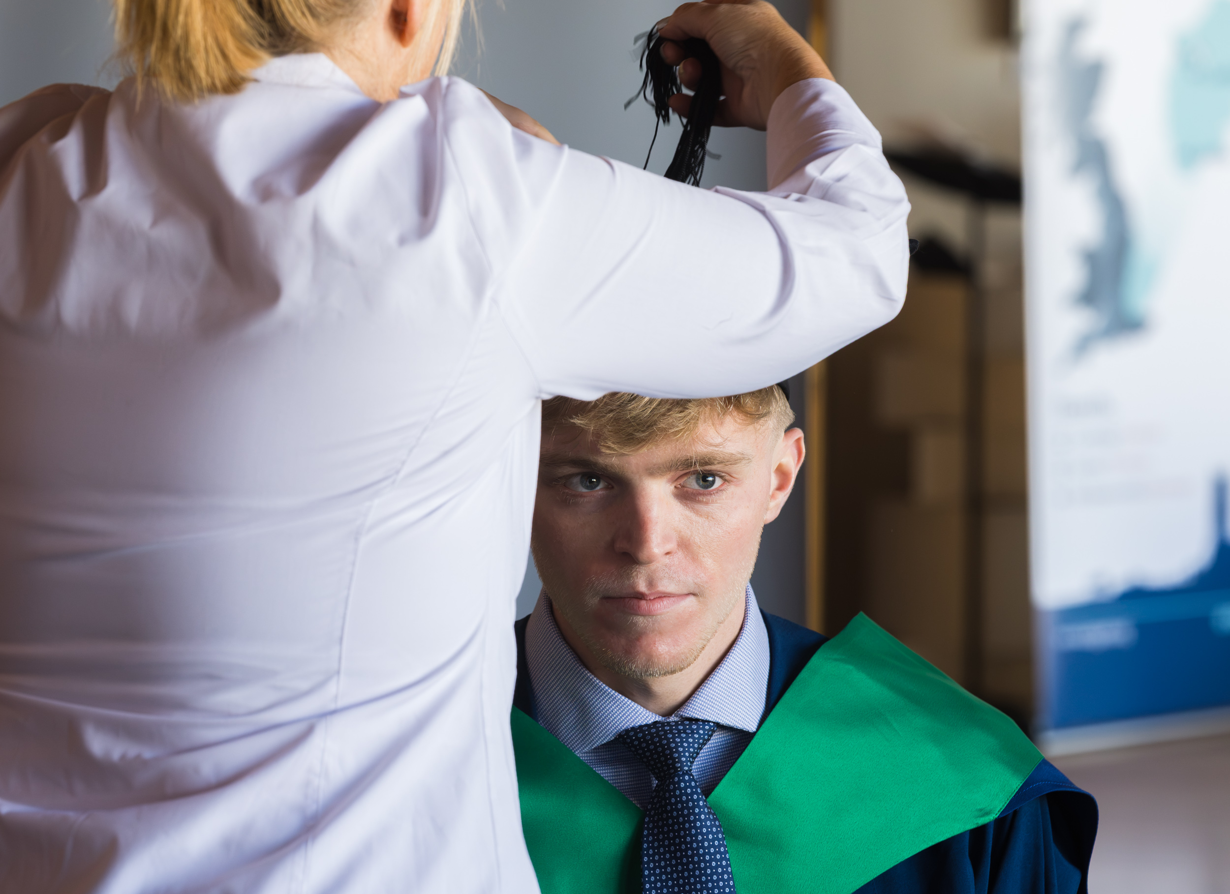 A graduate getting gowned up.