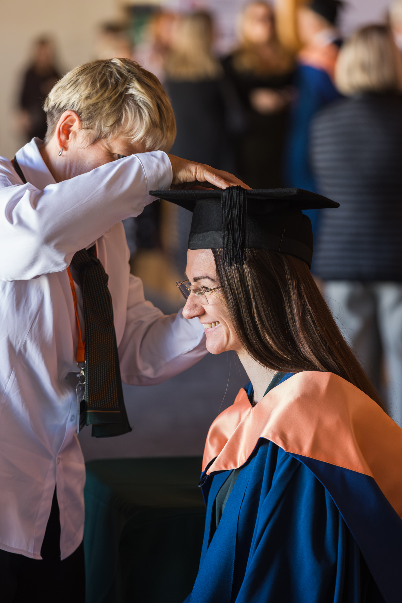 A graduate getting gowned up.