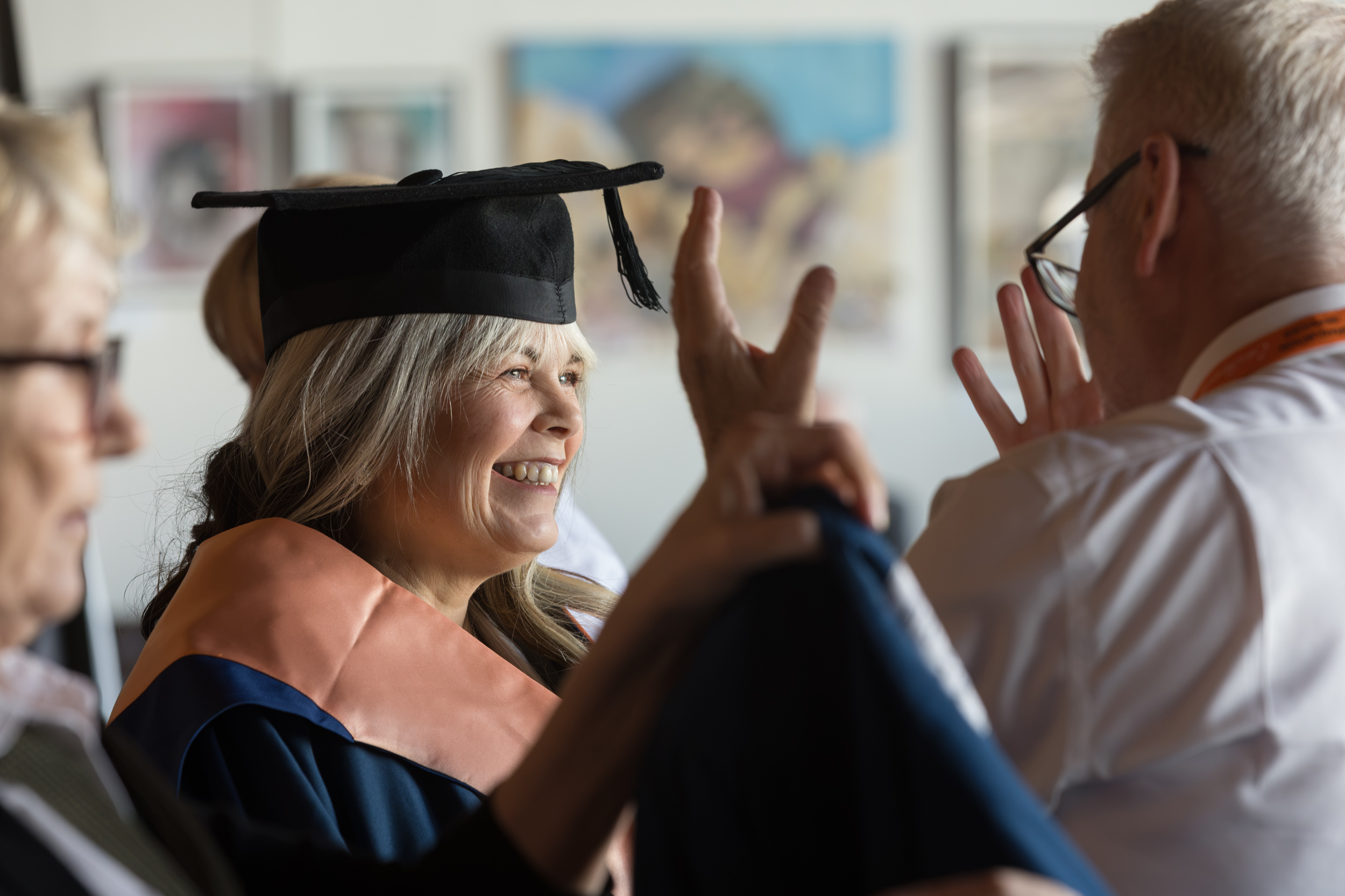 A graduate getting gowned up.