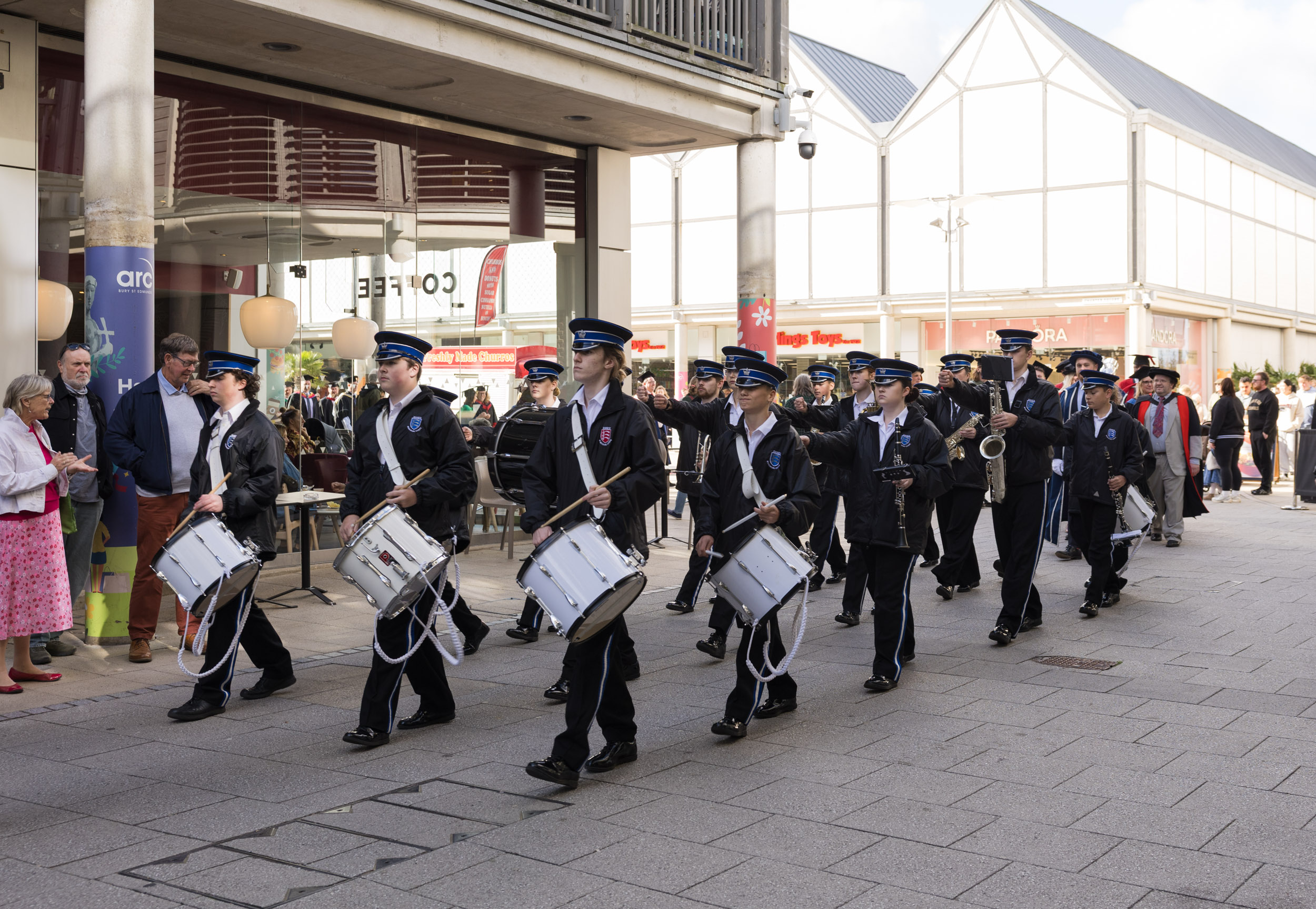Drummers and a marching band and the procession